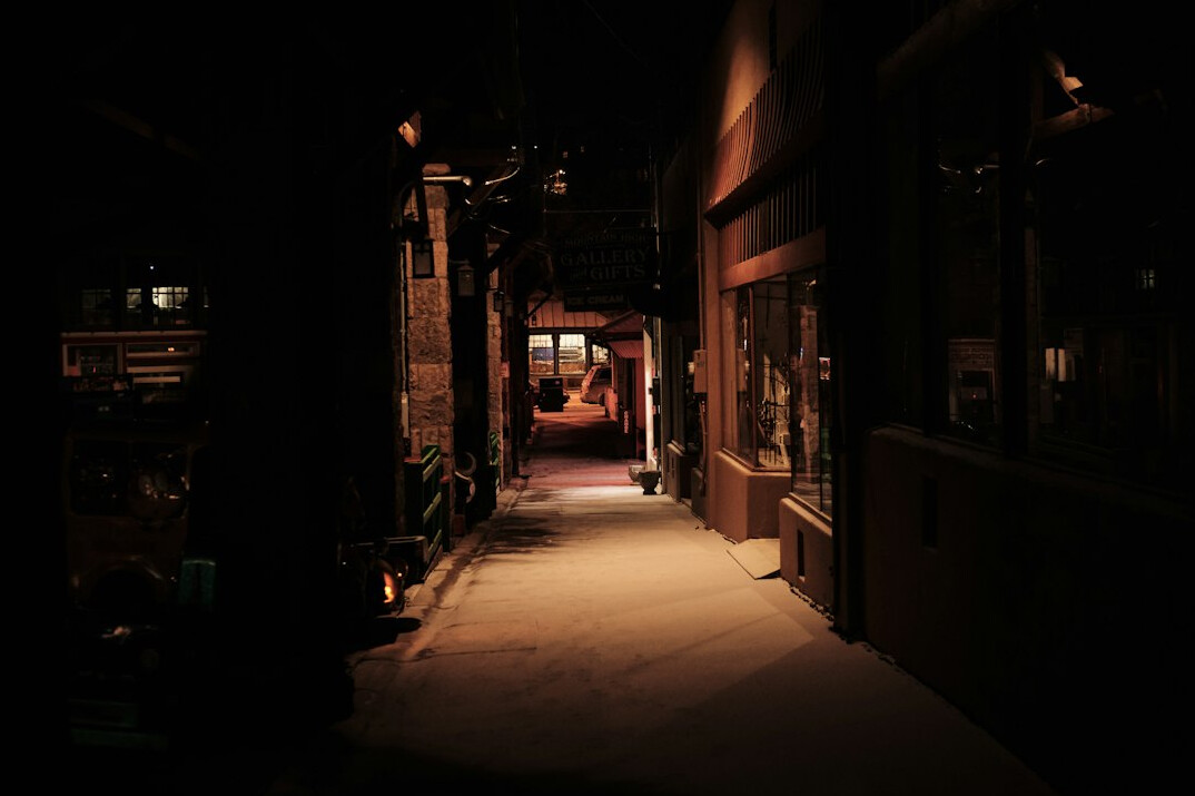 detective walking in dark alley